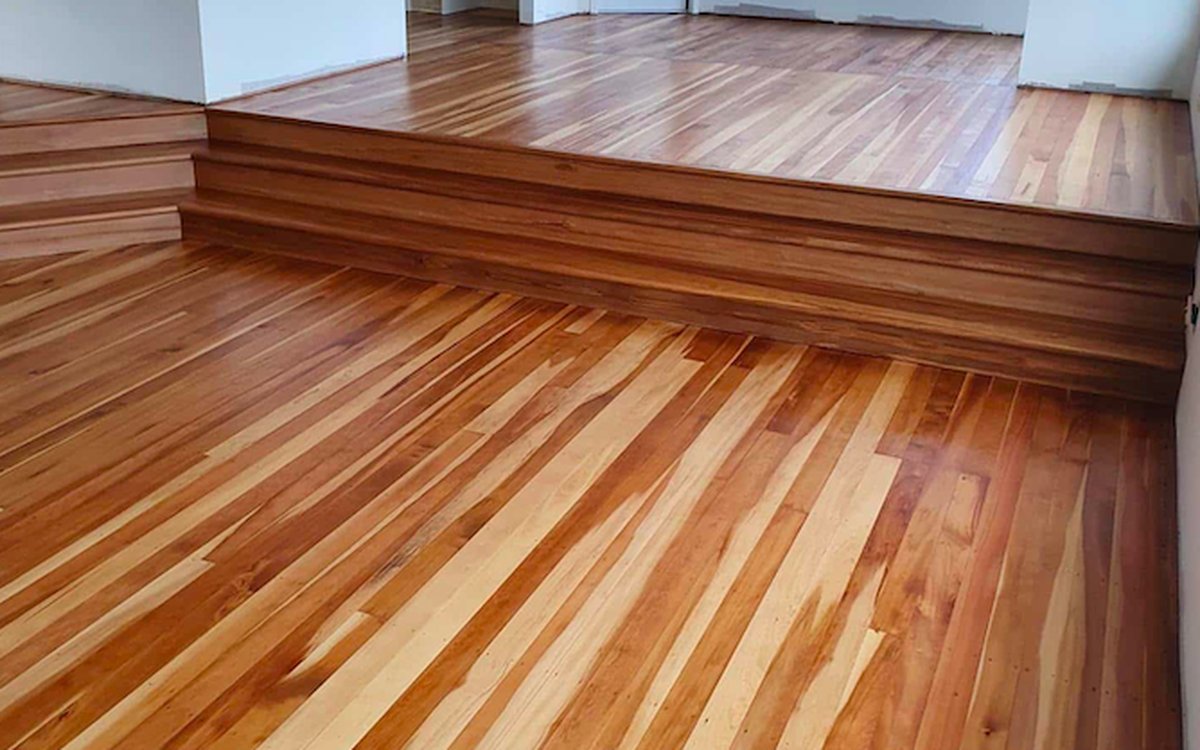 Natural oil finish on warm multi-tone timber floorboards in a living room