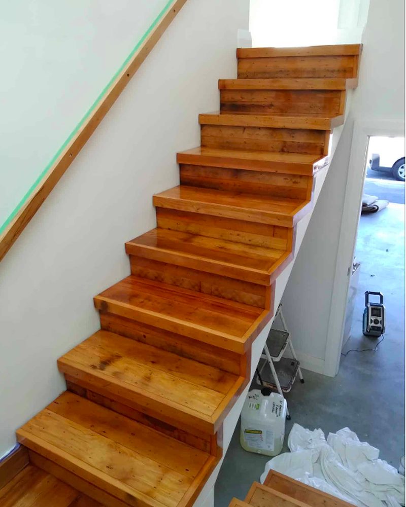 Finished polished timber staircase with a rich warm gloss finish after refinishing