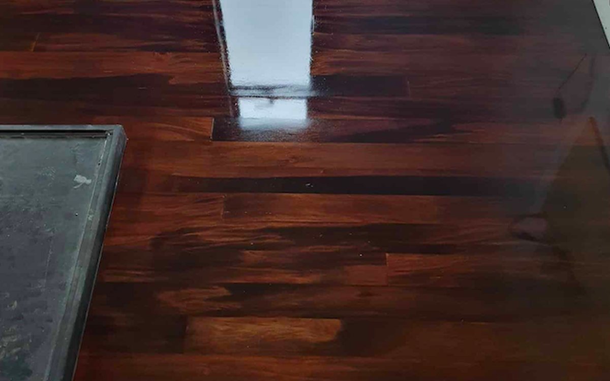 Deep walnut stained timber floor with a rich gloss finish after colour change