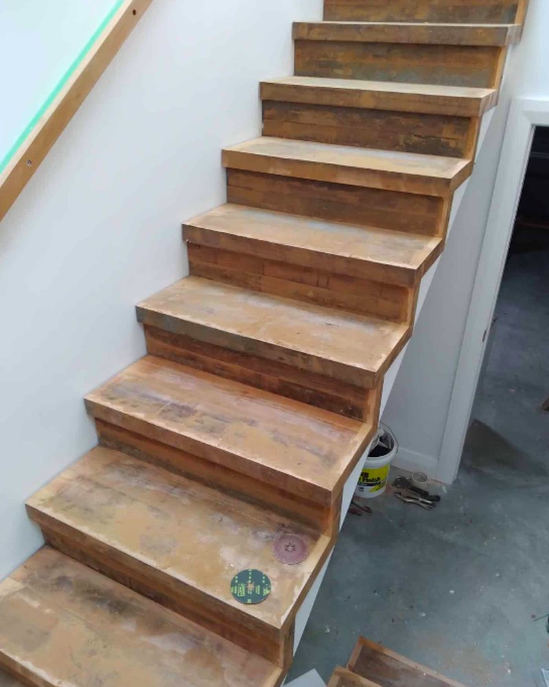 Bare sanded timber staircase treads before coating during a wooden floor restoration